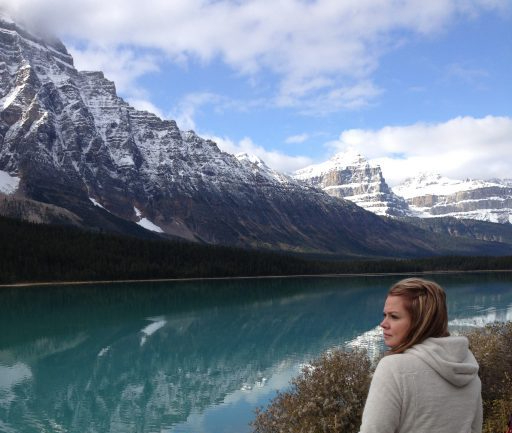 alt="woman in front of Canadian Rocky Mountain range"